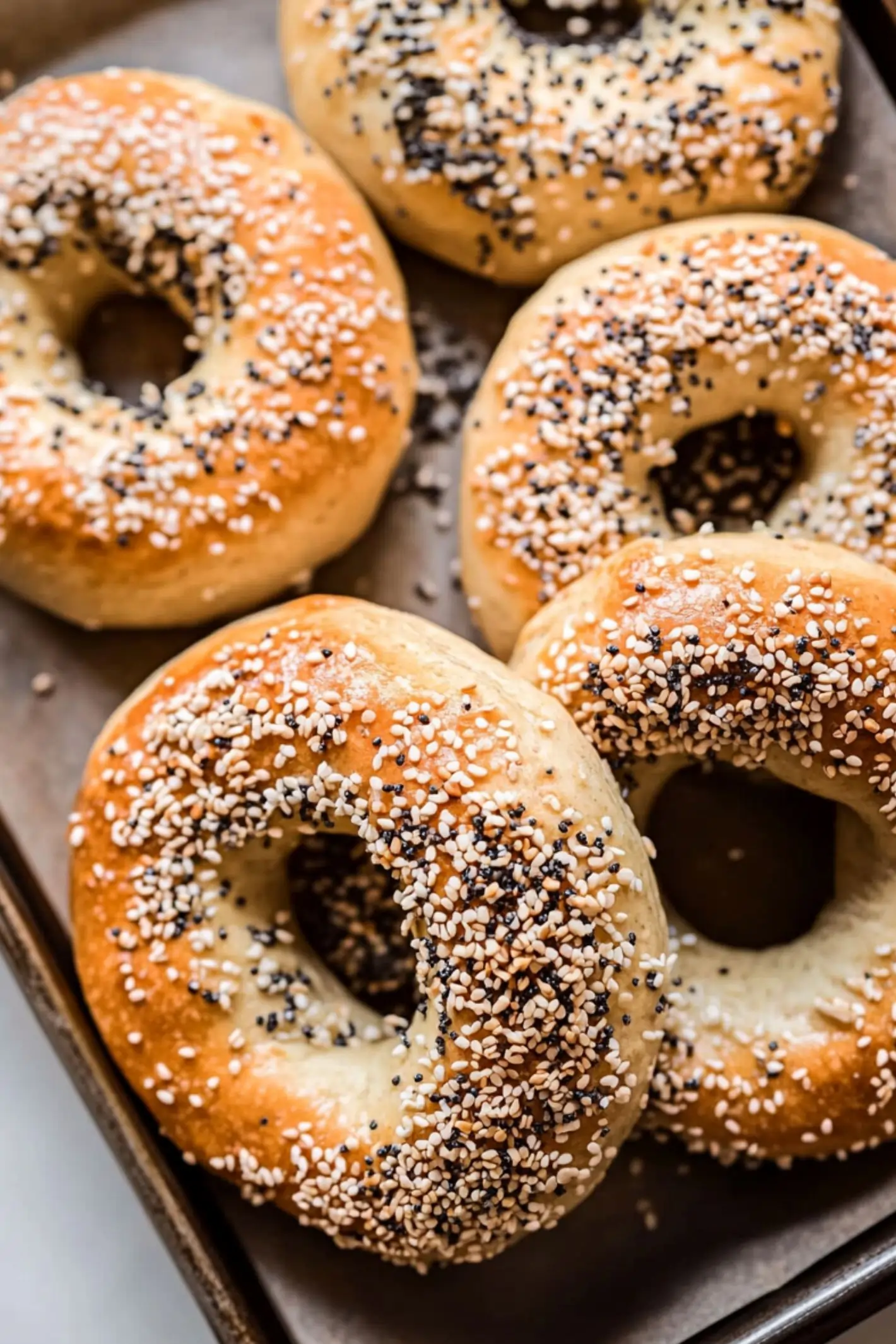 Close-up of freshly baked homemade high-protein bagels topped with everything bagel seasoning.