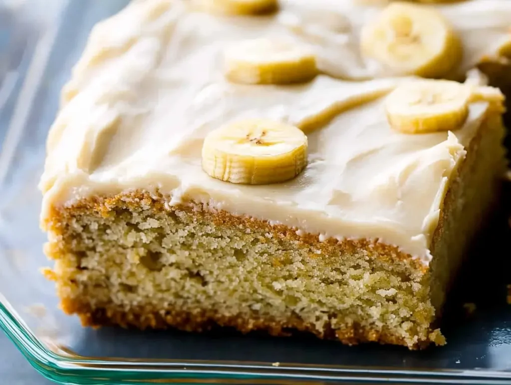 Close-up of soft and fluffy banana cake with smooth frosting, perfect for any occasion.