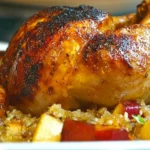 Glazed roasted chicken thigh served on a bed of caramelized apples and herbs.